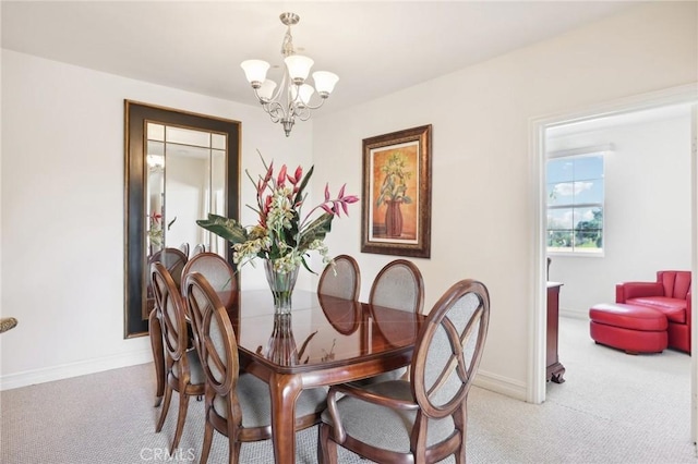 dining room featuring an inviting chandelier and light colored carpet