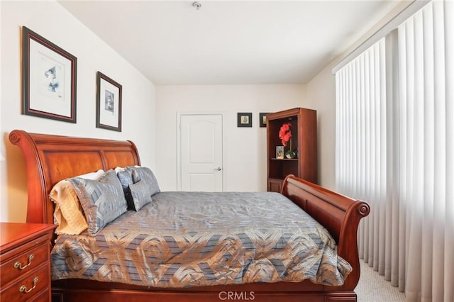 bedroom featuring light carpet