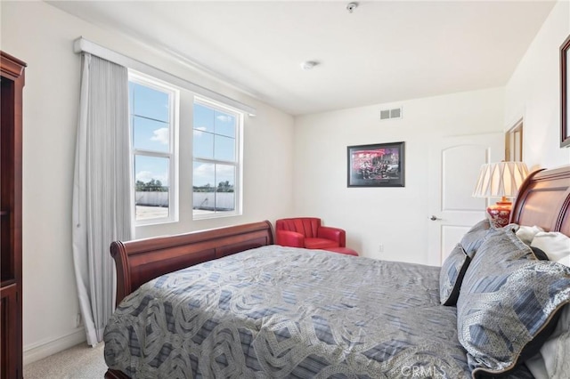 bedroom featuring light carpet