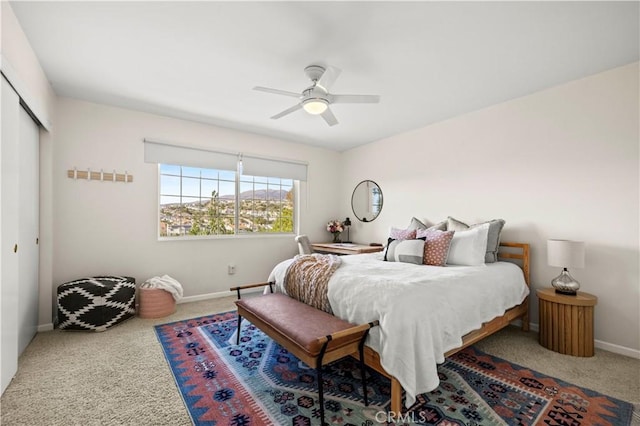 bedroom featuring ceiling fan, carpet, and a closet