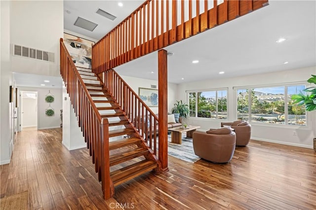 stairway with hardwood / wood-style floors