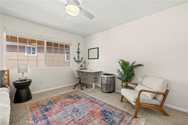 carpeted home office featuring ceiling fan