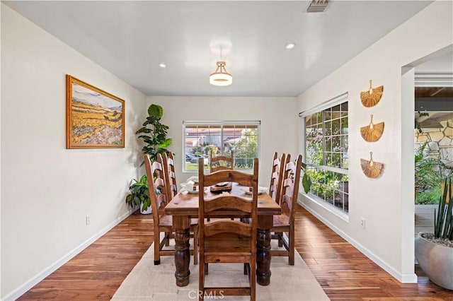 dining space with wood-type flooring