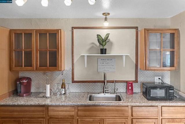 kitchen featuring sink and backsplash