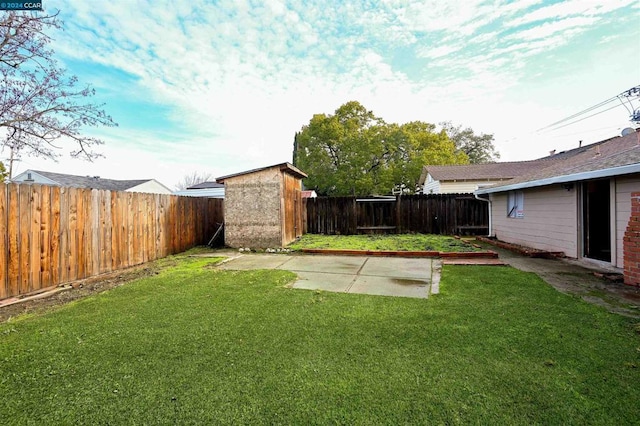 view of yard with a patio area and a storage unit