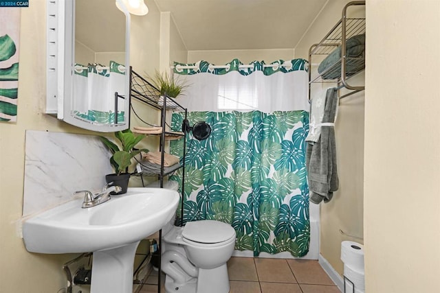 bathroom featuring toilet and tile patterned flooring