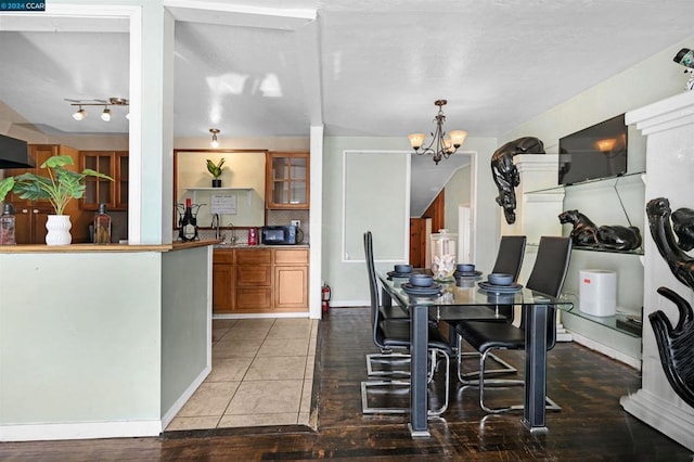 dining space with an inviting chandelier and tile patterned flooring