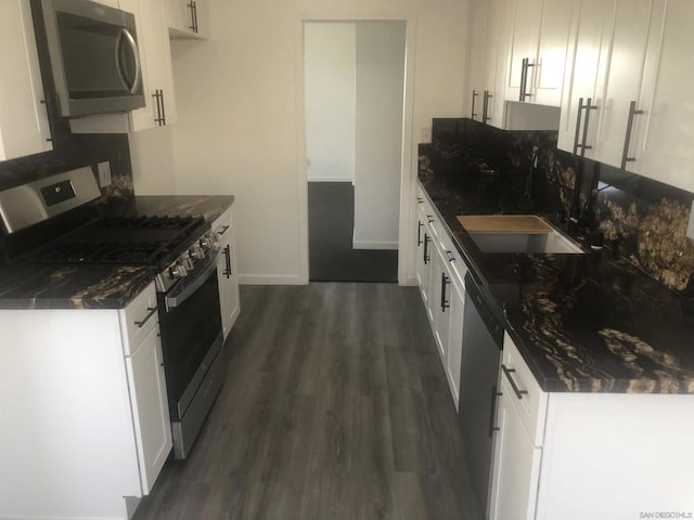 kitchen with appliances with stainless steel finishes, white cabinets, and sink