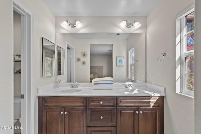 bathroom with toilet and vanity