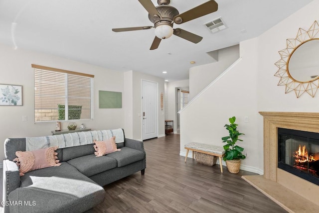 living room with ceiling fan and dark hardwood / wood-style flooring