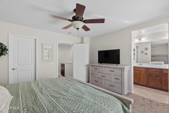 bedroom featuring ensuite bathroom, light tile patterned floors, ceiling fan, and sink