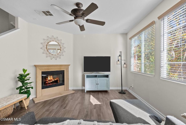 living room featuring ceiling fan and light hardwood / wood-style floors