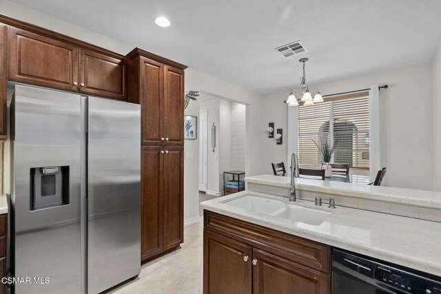 kitchen featuring stainless steel fridge, dishwashing machine, decorative light fixtures, a chandelier, and sink