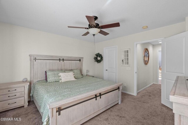 bedroom with ceiling fan and light colored carpet