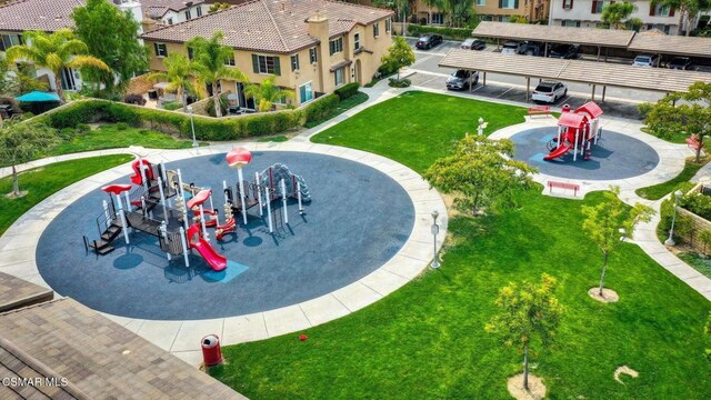 surrounding community featuring a playground and a lawn