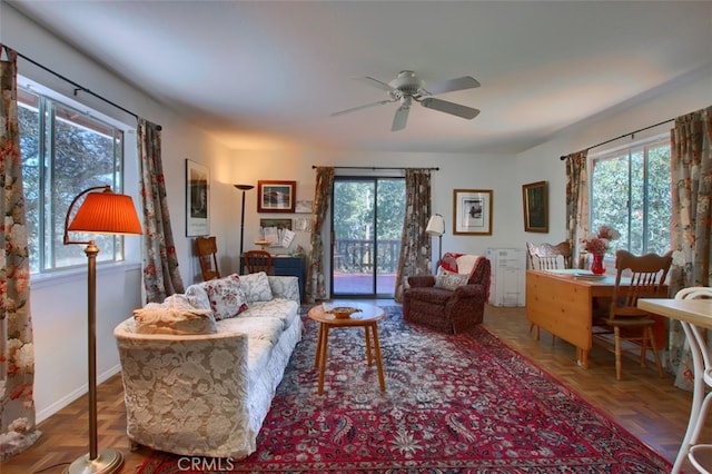 living room with ceiling fan, parquet flooring, and a wealth of natural light