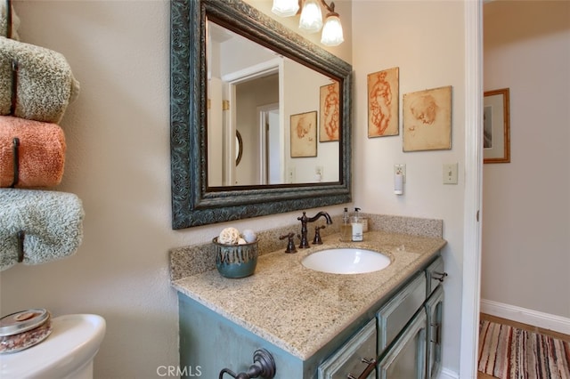 bathroom featuring toilet and vanity