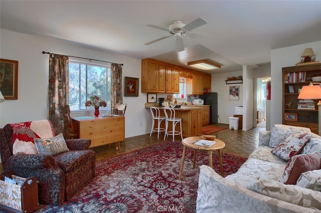 living room featuring ceiling fan and dark parquet flooring