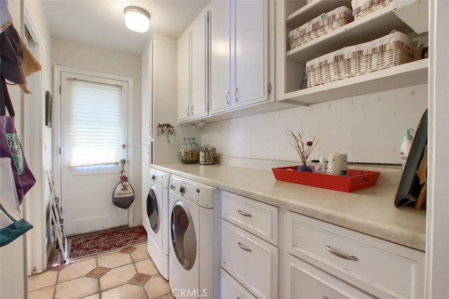 laundry area featuring cabinets and washing machine and clothes dryer