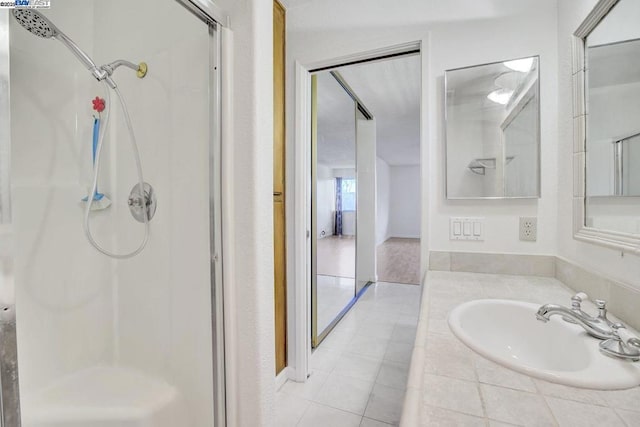 bathroom with vanity, tile patterned flooring, and an enclosed shower