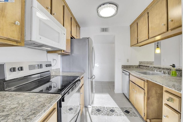 kitchen with light tile patterned floors, stainless steel appliances, pendant lighting, and sink