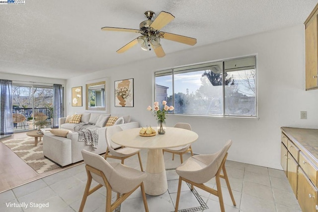 dining space with ceiling fan, a healthy amount of sunlight, and light tile patterned flooring