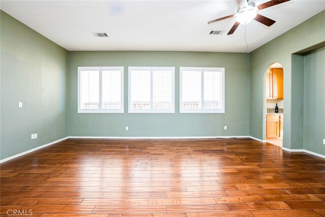 unfurnished room featuring ceiling fan and wood-type flooring