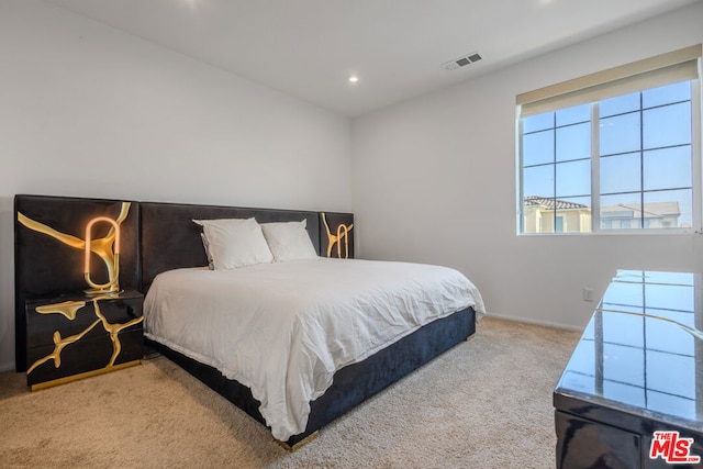 bedroom featuring light carpet