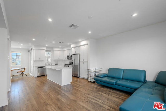 living room with sink and hardwood / wood-style flooring