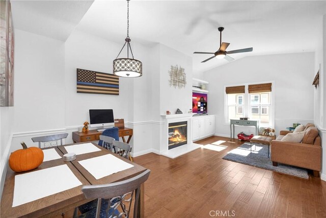 living room featuring ceiling fan, hardwood / wood-style floors, and lofted ceiling