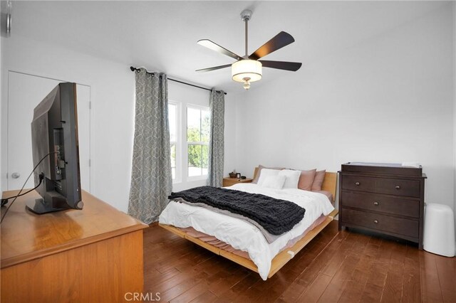 bedroom with ceiling fan and dark hardwood / wood-style flooring