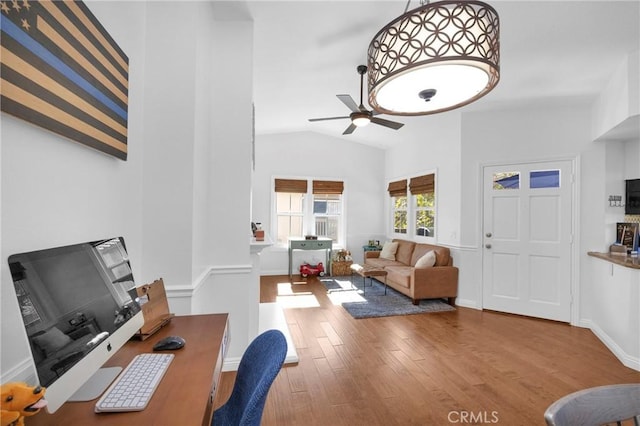 office with baseboards, wood finished floors, a ceiling fan, and vaulted ceiling