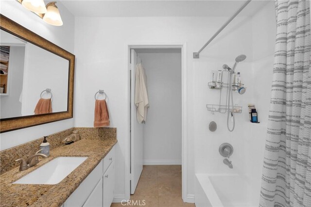 bathroom with shower / tub combo with curtain, tile patterned flooring, and vanity