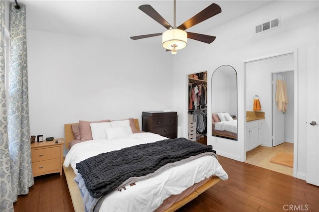 bedroom with visible vents, a closet, hardwood / wood-style floors, and a spacious closet