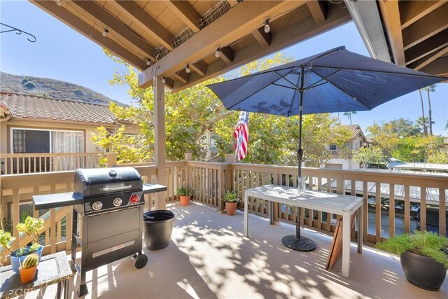 view of patio / terrace with a wooden deck and area for grilling