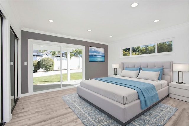 bedroom with access to exterior, crown molding, and light hardwood / wood-style flooring