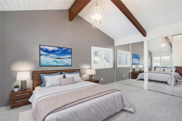 bedroom with high vaulted ceiling, beam ceiling, multiple closets, light carpet, and an inviting chandelier