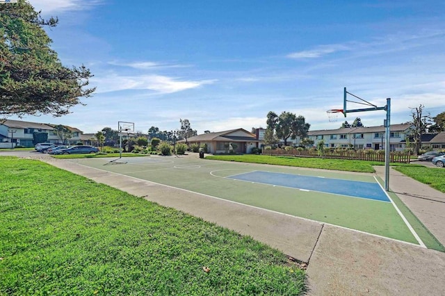 view of basketball court featuring a yard