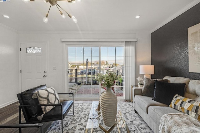 living room featuring crown molding, a chandelier, and hardwood / wood-style floors