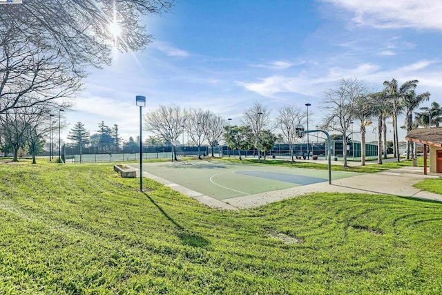 view of basketball court featuring a lawn