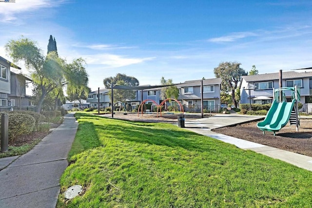 view of home's community with a playground and a lawn