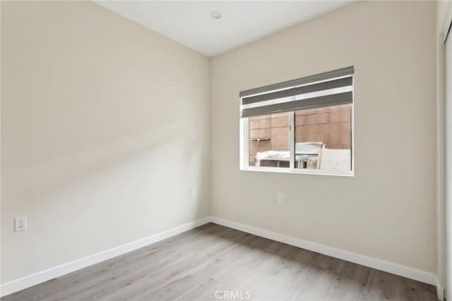 spare room featuring hardwood / wood-style flooring