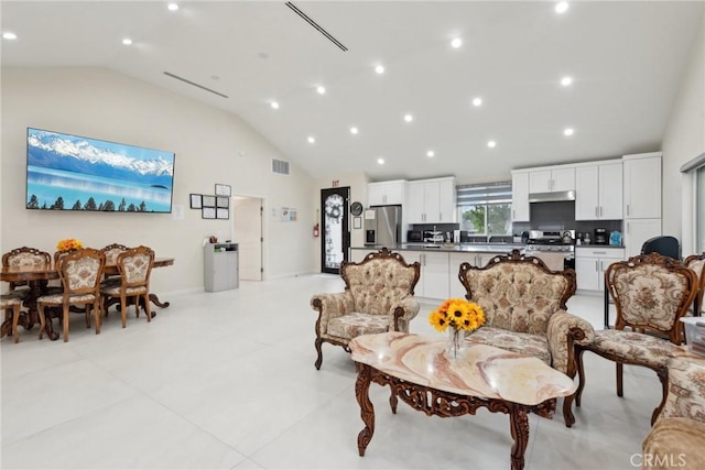 living room featuring high vaulted ceiling