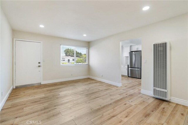 unfurnished living room with light hardwood / wood-style flooring