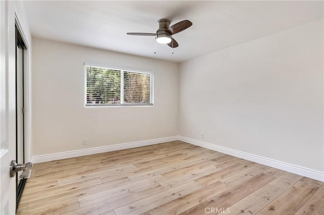 empty room with ceiling fan and light wood-type flooring