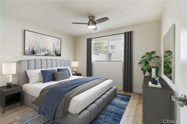 bedroom with ceiling fan and light hardwood / wood-style floors