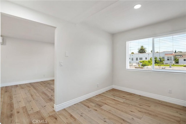 spare room with light wood-type flooring