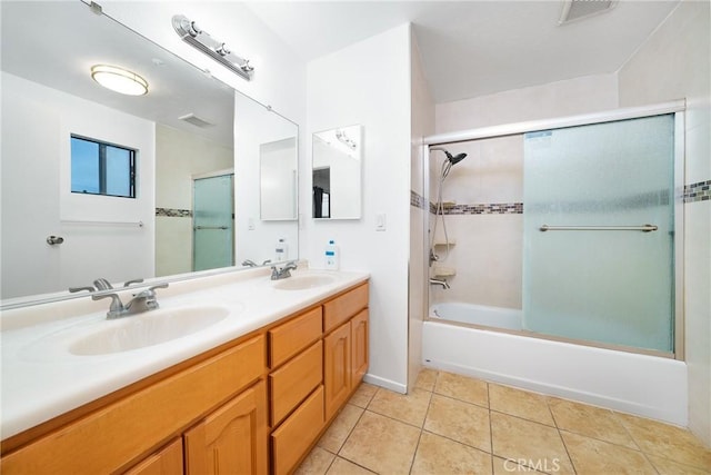 bathroom featuring bath / shower combo with glass door, tile patterned flooring, and vanity