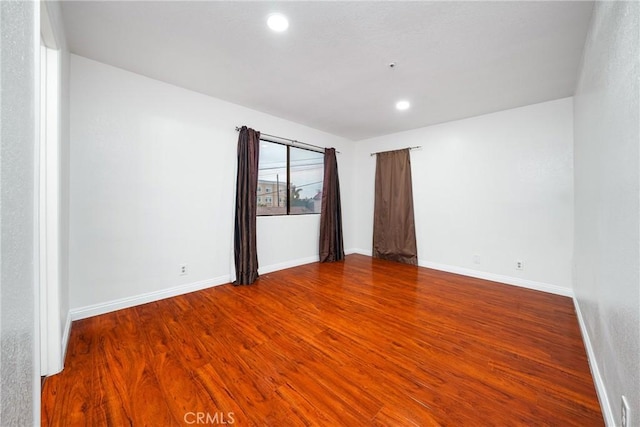 unfurnished room with hardwood / wood-style floors