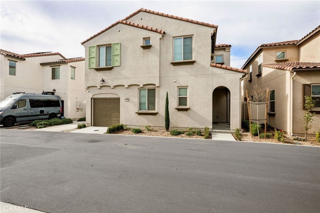 mediterranean / spanish house featuring a garage